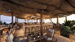 rooftop bar and restaurant with draped canvas roof and natural textures and colours at Île de Bendor
