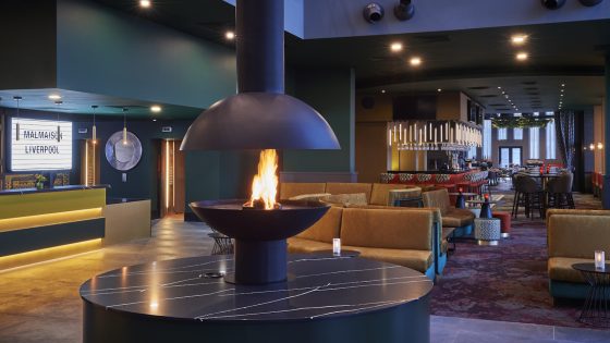 A large fireplace in the middle of lobby/lounge in Liverpool hotel
