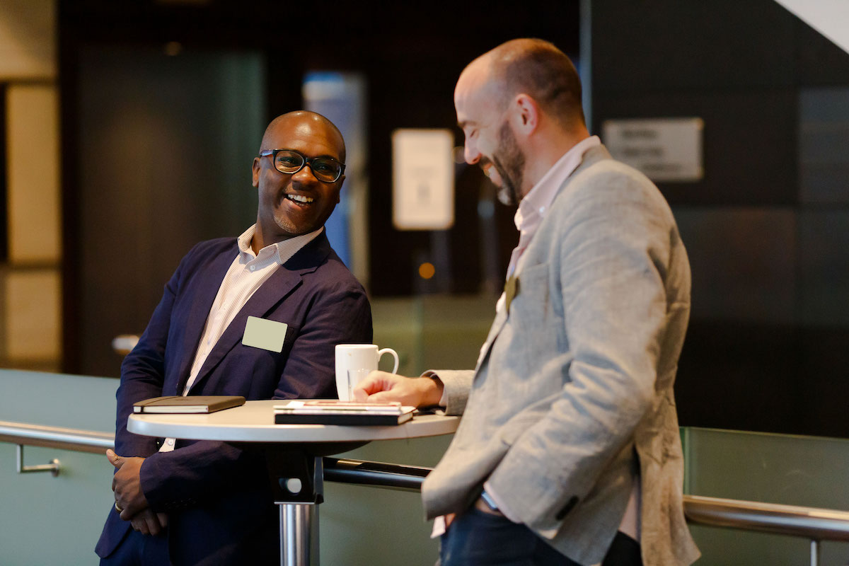 Two men networking at a Forum Events Summit