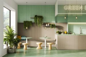 seating and bar in a cafe with green signage and plants and a green and wood veneered surface and wall treatment from James Latham