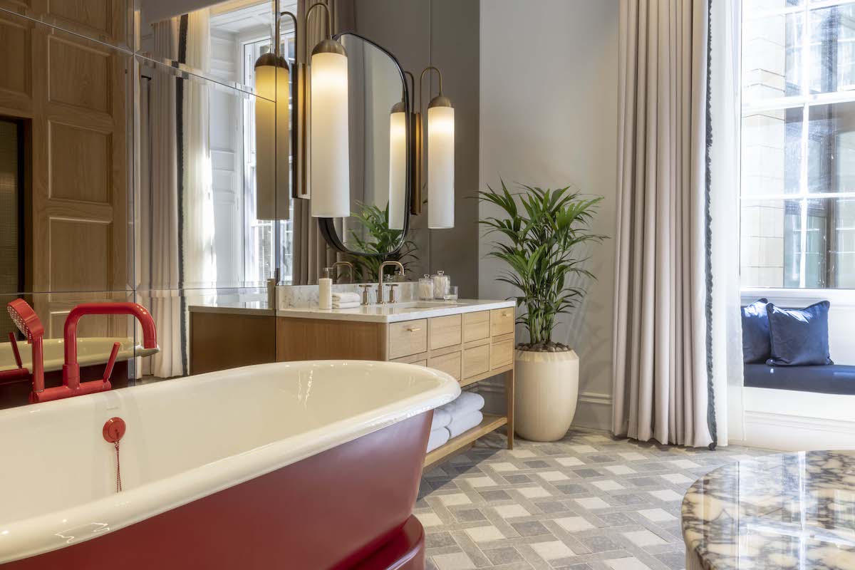 Image caption: Designed to be unapologetically different – think statement-red bath tubs and taps – Richard's Flat inside Virgin Hotels Edinburgh in one of the property's premium suites / chambers. | Image credit: Virgin Hotels