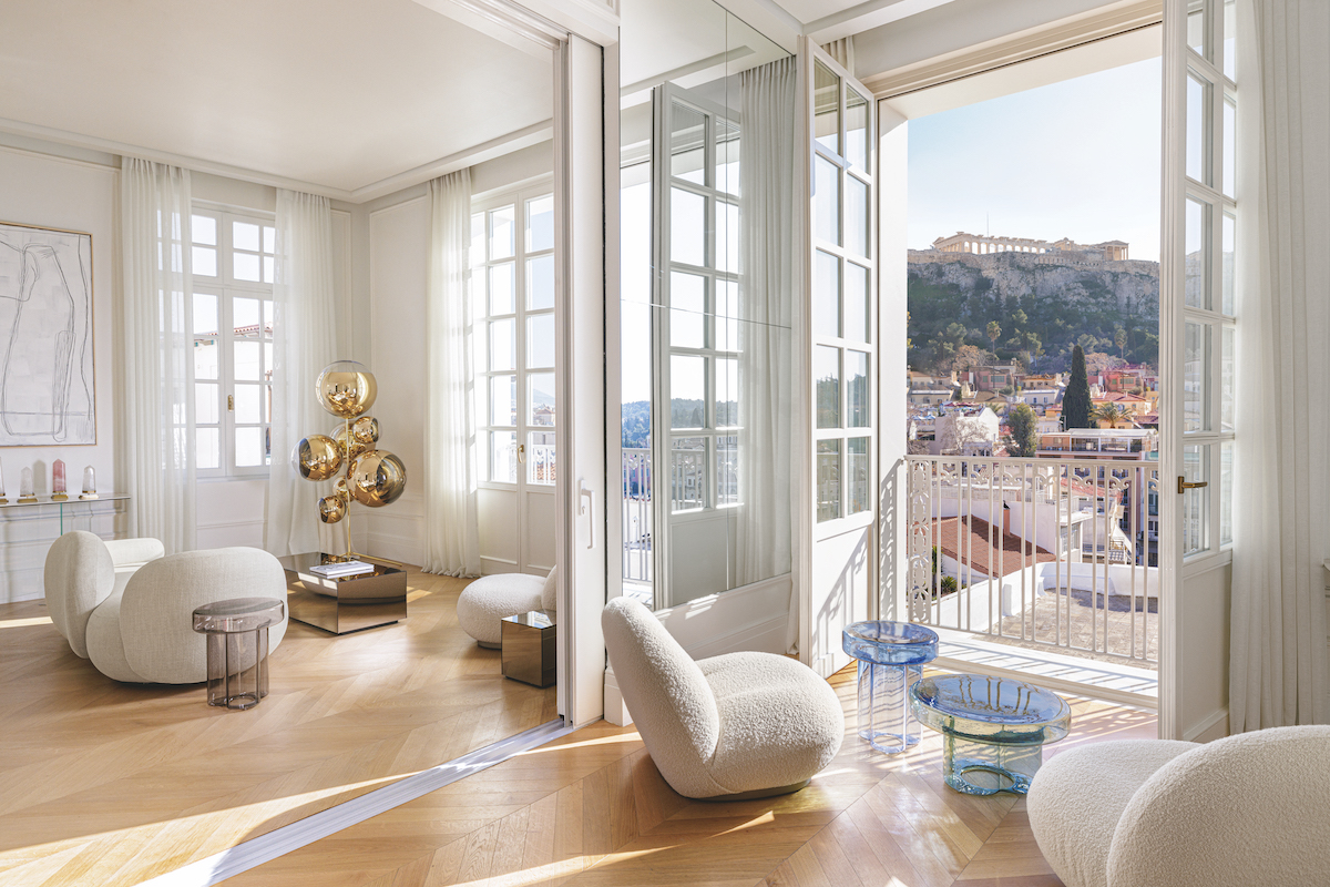 A penthouse suite with floor to ceiling windows that look out onto the acropolis
