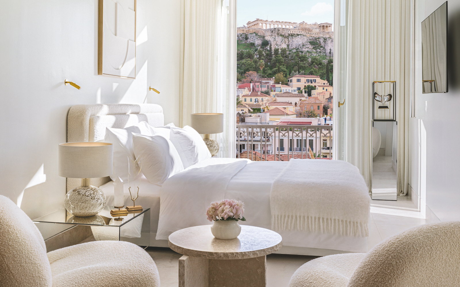 A white suite in luxury hotel in Athens that has a view of the acropolis