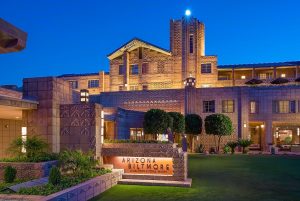 facade and entrance to Arizona Biltmore resort with statement brick and stone work lit up