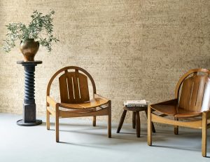 a pair of mid-century modern chairs in front of textured wall covered in ajoura from the Arte Les Forets collection