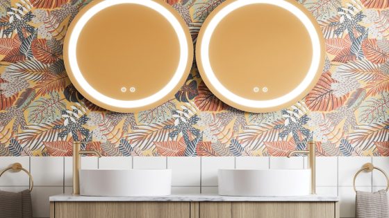 round bathroom mirrors above round double basin on a wooden vanity unit by Britton.