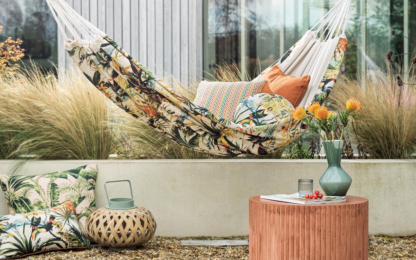 cushions, lantern and outdoor hammock in tropical floral alfresco fabric from Clarke & Clarke