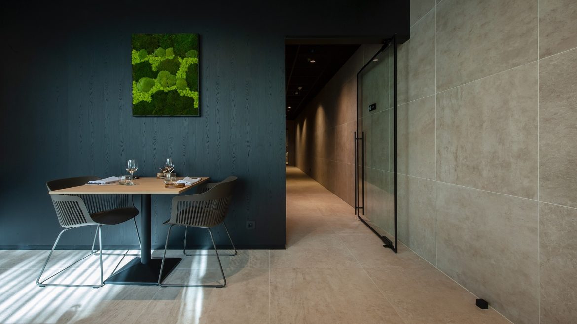 hotel seating and table against panelled wall in dark wood master oak unilin melamine