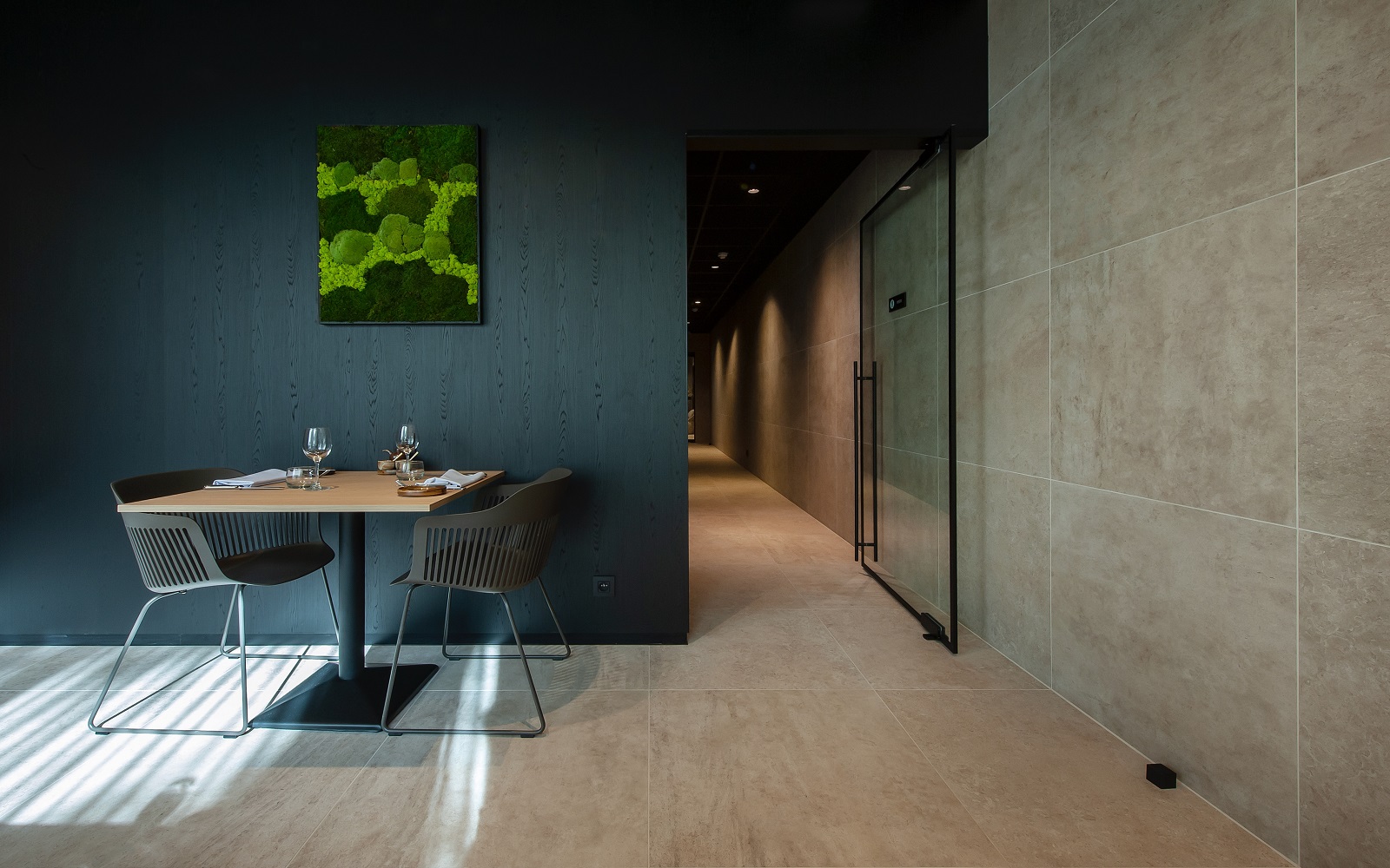 hotel seating and table against panelled wall in dark wood master oak unilin melamine