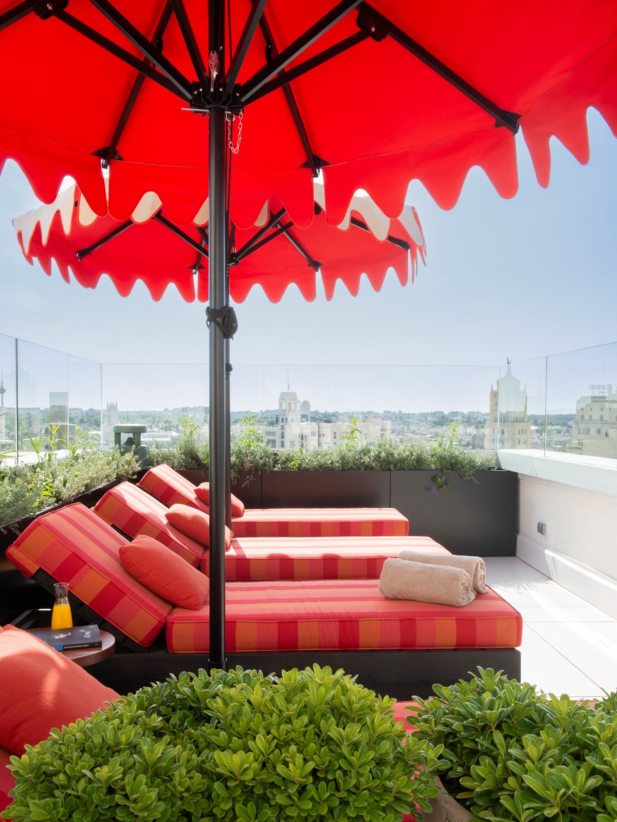 red parasols and red sun loungers on the roof terrace of Hotel Montera Madrid