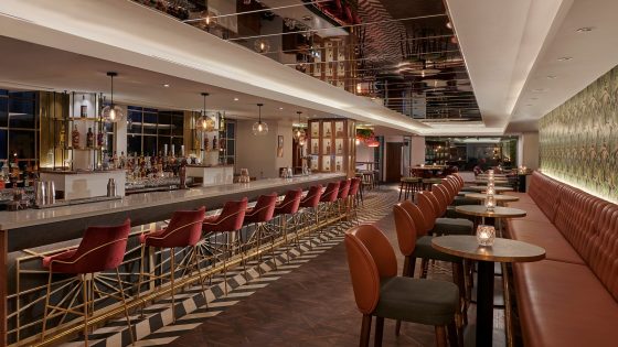 leather banquettes and high stools at round tables and along the bar in the Hyatt Regency London Blackfriars bar