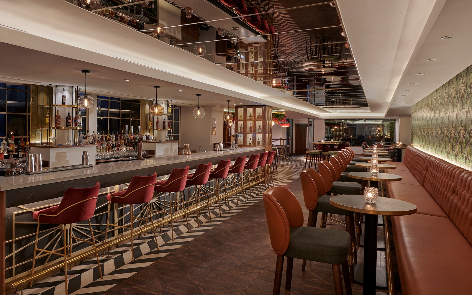 leather banquettes and high stools at round tables and along the bar in the Hyatt Regency London Blackfriars bar