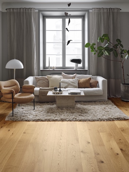 A modern living room with wood-like floor