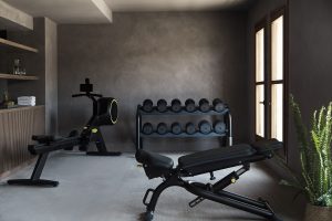 concrete walls and floor in the gym with contrasting black equipment