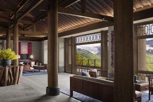 traditional tibetan design in hotel lobby with furniture facing picture windows looking out over the mountains