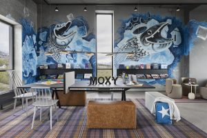 concrete grey walls with mural depicting water and fish from the fjords outside on the wall in moxy tromso