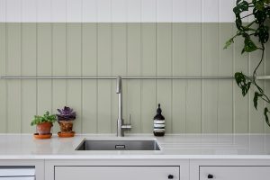 kitchen with wood panelling painted in white and Proper good Paint Birdies Grey from Hyperion Tiles