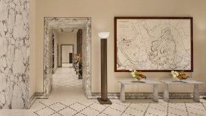 reception of Bulgari Roma hotel with marble on walls and map of the city