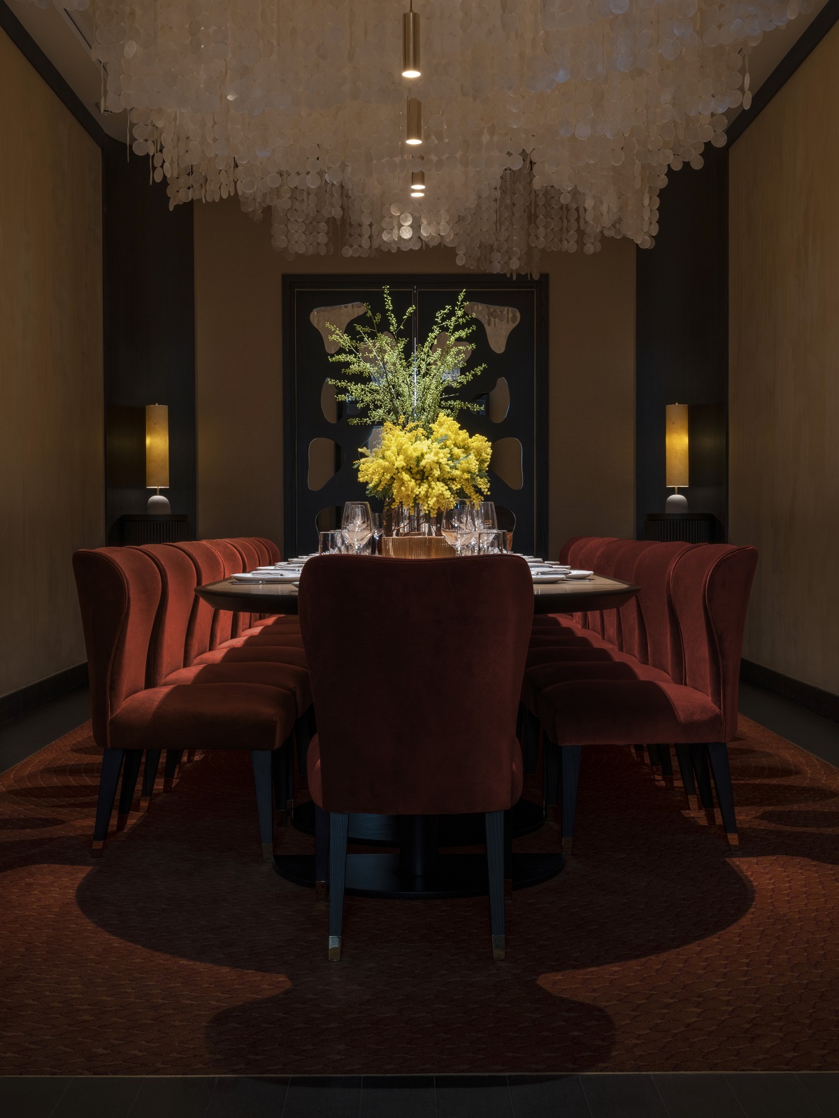 view across table with floral arrangement in the private dining space of Scarpetta