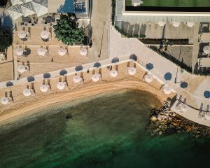 aerial view of beach and hotel with white umbrellas and sun terraces at Hyatt Regency Kotor Bay Resort
