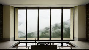 zen inspired sunken bath with minimalist window frames framing mountain view