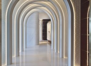 white marble curved arches in the Waldorf Astoria Lusail leading into the spa area