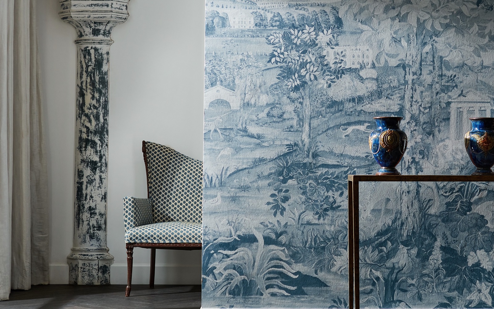 blue column against a white wall in the background with wallpapered foreground in blue zoffany arcadian collection