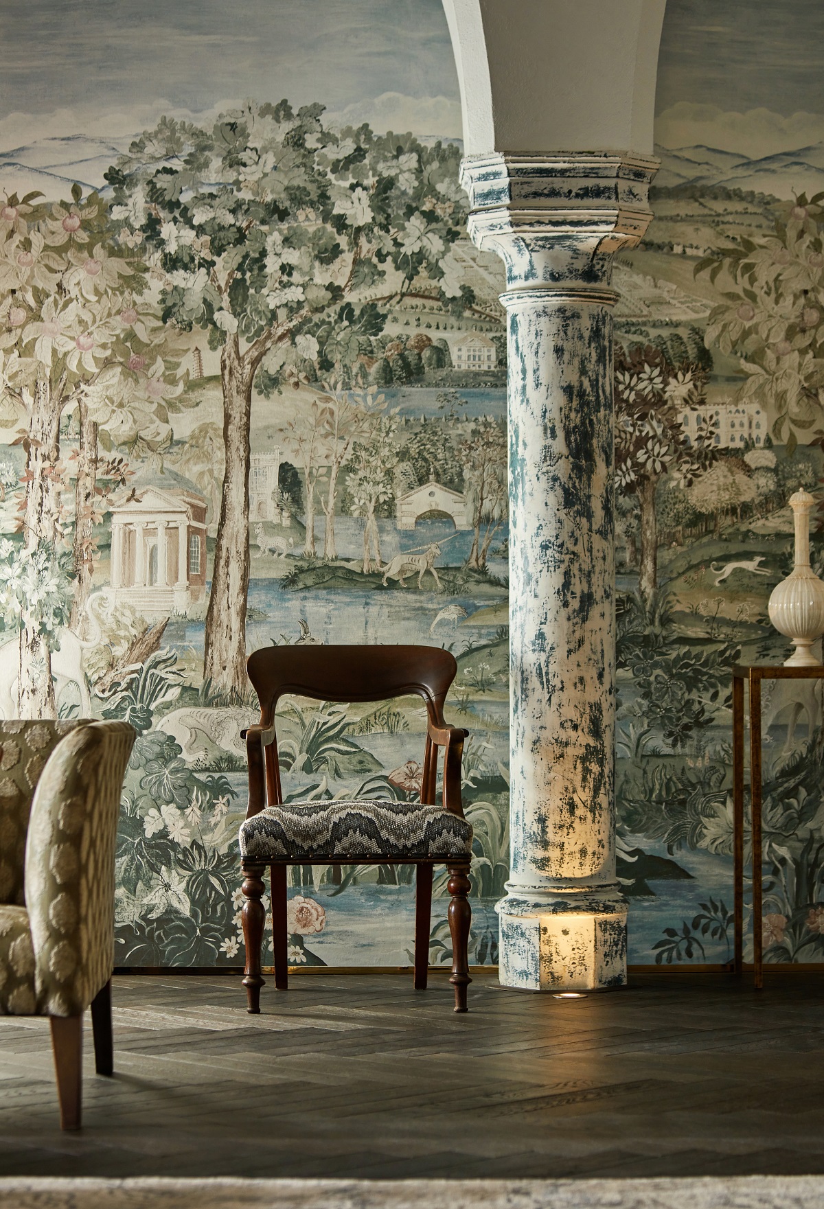 wall covered in zoffany arcadian thames wallpaper with distressed column and chair