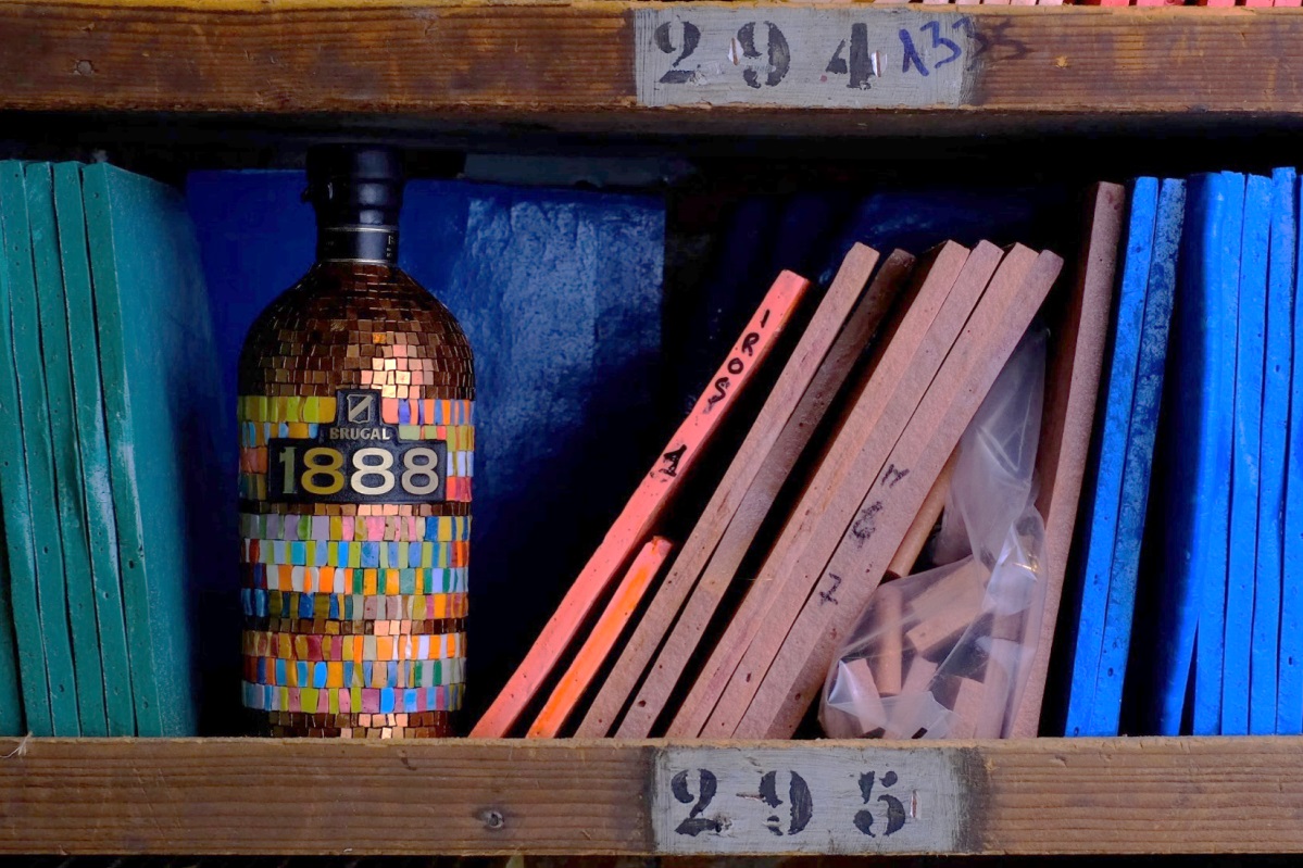 old wooden library shelf in the orsoni mosaic library with bottle decorated in mosaic tiles
