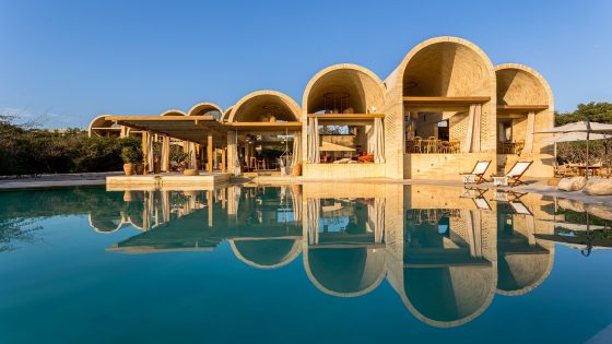 vaulted architecture and design of Casona Sforza overlooking the pool with reflections of the building in the water