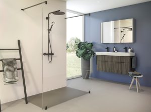 contemporary bathroom in grey and white with wood surfaces and black fittings with a clear glass shower enclosure and flush concrete grey shower tray