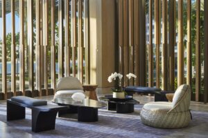 organic rounded furniture in front of wooden screened window in Waldorf Astoria Cancun