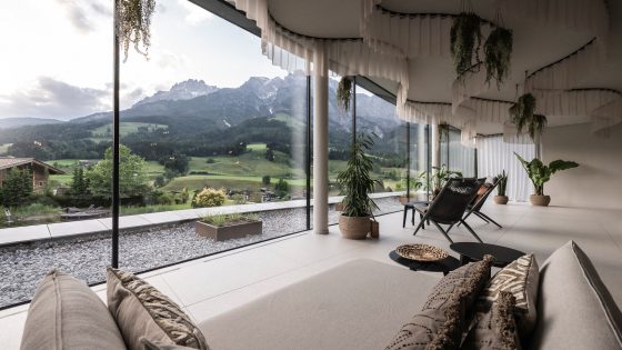 curved ceiling above floor to ceiling windows looking across to the mountains from Puradies resort by NOA