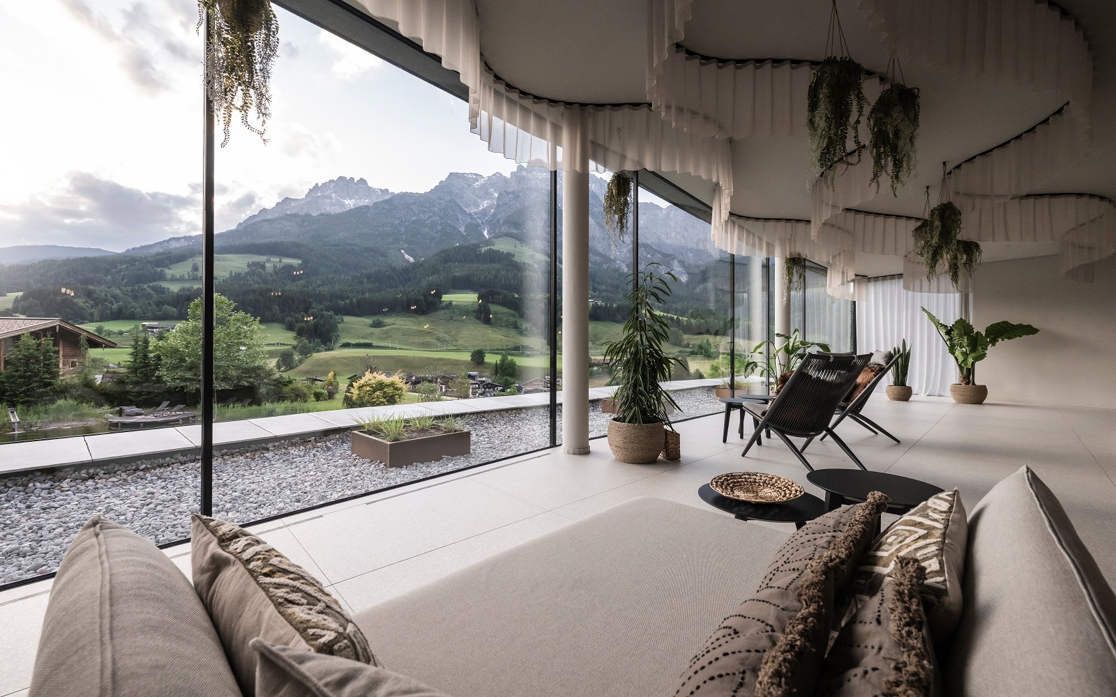 curved ceiling above floor to ceiling windows looking across to the mountains from Puradies resort by NOA