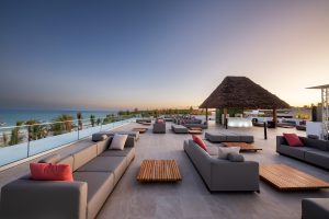 outdoor couches and tiled floor around pool overlooking the beach in Zanzibar