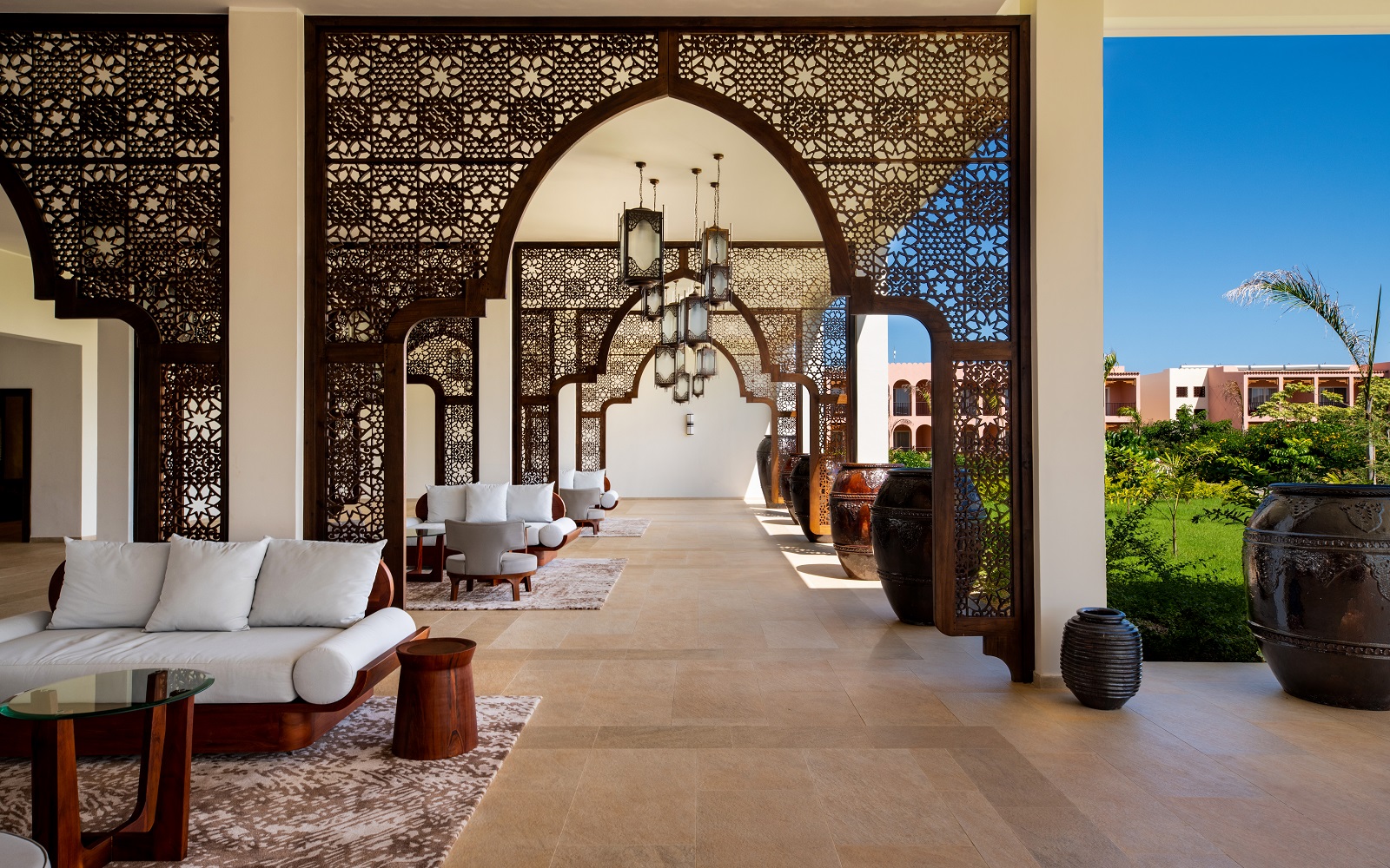 arabic screens and stone coloured tiles from Atals Concorde line the corridor at the Zanzibar resort