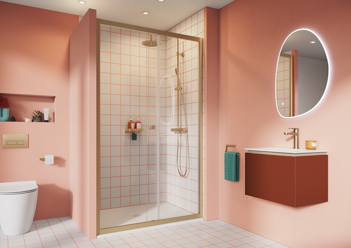 pink painted bathroom walls contrast with white tiled bathroom enclosure with gold trim