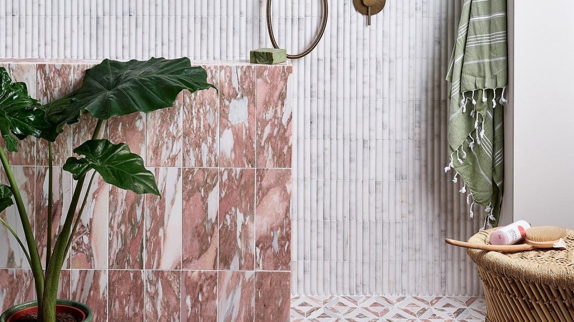 pink and brown marble bathroom tiles from Hyperion tiles contrast with green accessories and textured stone coloured wall and floor tiles