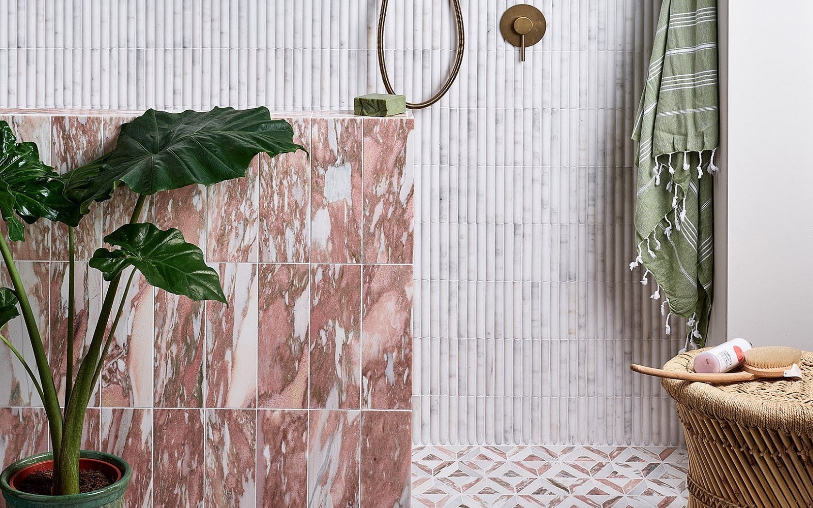 pink and brown marble bathroom tiles from Hyperion tiles contrast with green accessories and textured stone coloured wall and floor tiles
