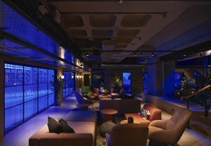 blue lighting and focussed spotlighting in the public seating area in YOTEL Glasgow designed by Artin light