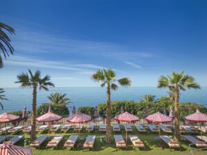 swimming pools, seaview with red and white striped parasols and sunloungers