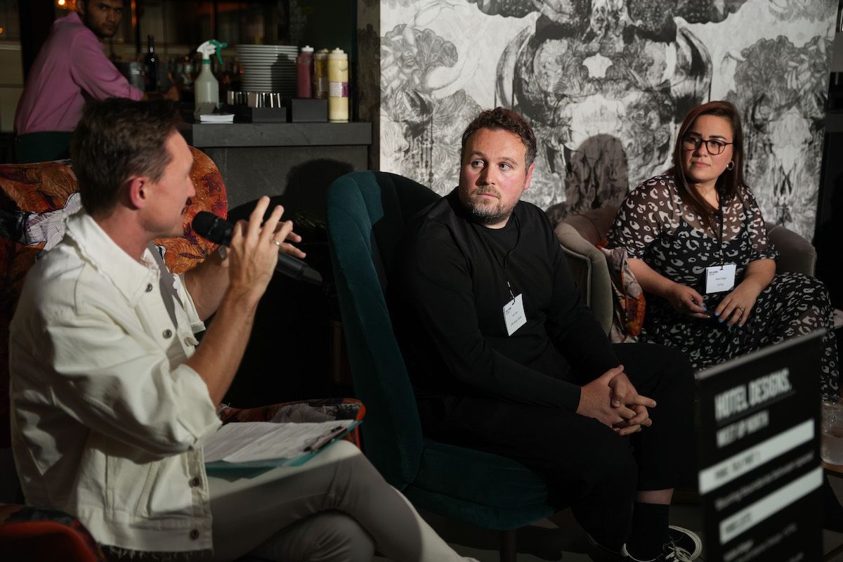 Hamish Kilburn, Editor of Hotel Designs, moderating a panel with Joe Lane and Katie Edgar in the frame
