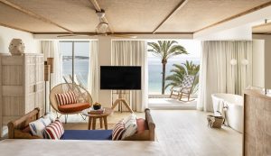 guestroom at ZEL Mallorca looking across seating and bathroom out to terrace and seaview