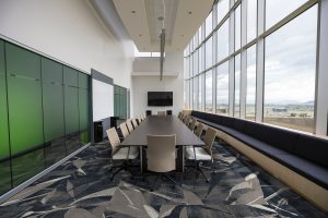 meeting room with table and seating on a faceted patterned carpet made up from carpet tiles