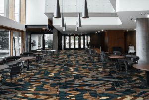 wide corridor in a commercial space with brown and black carpet in Modieus Quartz carpet tiles