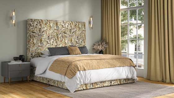bedroom with sand coloured floor to ceiling curtains and a floral patterned headboard
