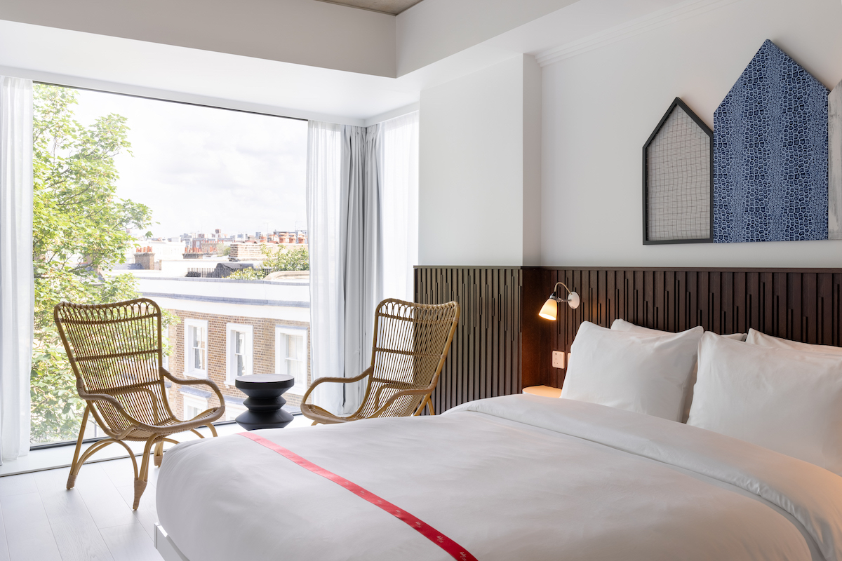 A clean, white guestroom in Notting Hill hotel