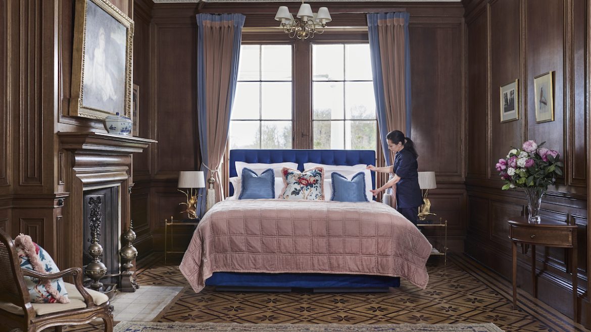 a plush looking hotel room with pink and blue bed