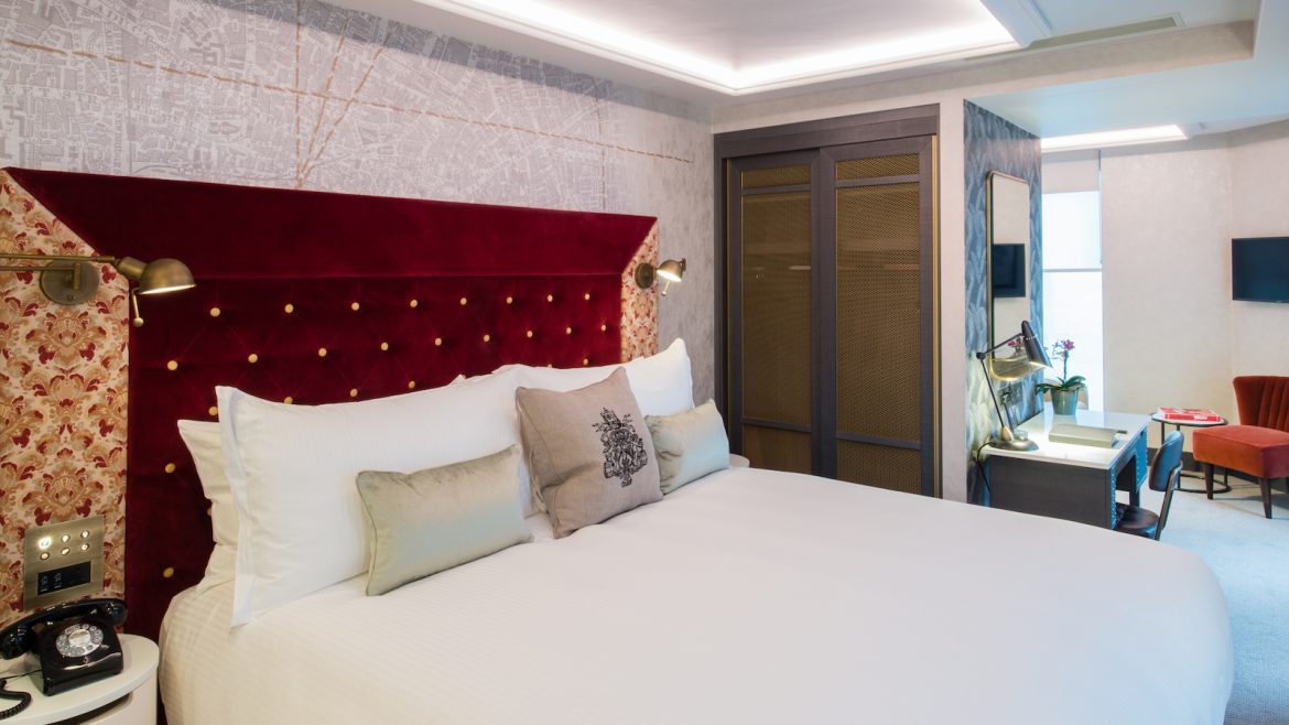 Vintry & Mercer suite hotel room with ruby red headboard