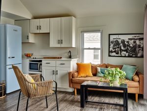 an aparthotel style cottage at York Beach surf club with scandi style furniture, a blue retro fridge and vintage photographs